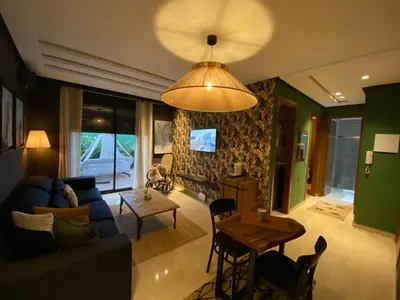 a living room with a blue couch and a table at Cozy private jacuzzi spa apartment in Casablanca