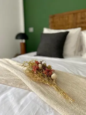 a bouquet of flowers on top of a bed at Cozy private jacuzzi spa apartment in Casablanca