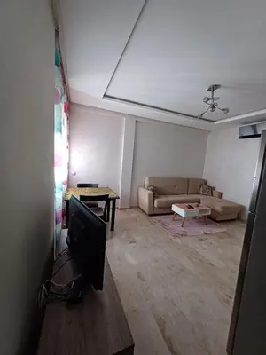 a living room with a tv and a couch at Apartment kamal park G39 in Mohammedia