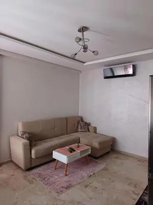a living room with a couch and a coffee table at Apartment kamal park G39 in Mohammedia