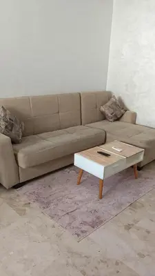 a living room with a couch and a coffee table at Apartment kamal park G39 in Mohammedia
