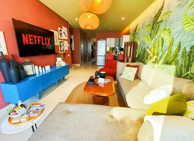 a living room with a couch and a tv at Maya Suites - Luxury Stay in Casablanca in Casablanca