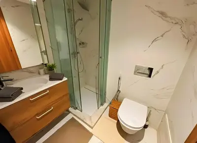 a bathroom with a shower and a toilet and a sink at Maya Suites - Luxury Stay in Casablanca in Casablanca