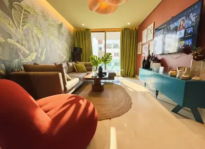a living room with a couch and a tv at Maya Suites - Luxury Stay in Casablanca in Casablanca