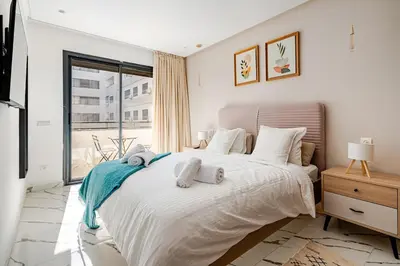 a bedroom with a large bed with towels on it at Cozy studio 5 min from Casa Port and Casa Voyageurs in Casablanca