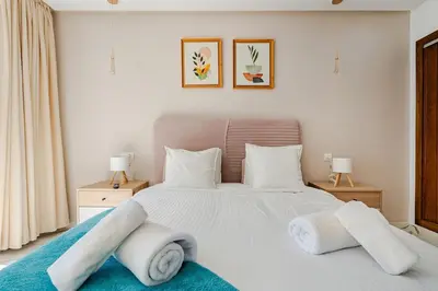 a bedroom with a white bed with towels on it at Cozy studio 5 min from Casa Port and Casa Voyageurs in Casablanca