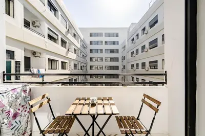 a table and chairs on the balcony of a building at Cozy studio 5 min from Casa Port and Casa Voyageurs in Casablanca