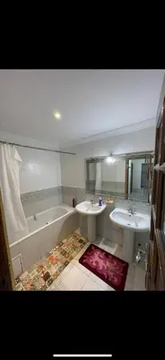 a bathroom with two sinks and a bathtub and a tub at Bd les iris in Casablanca