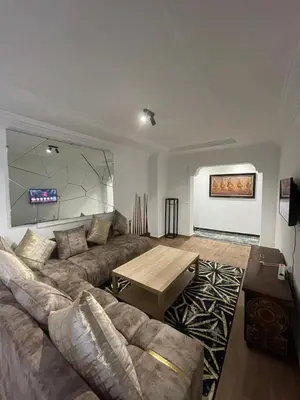 a living room with a couch and a table at Bd les iris in Casablanca