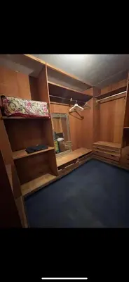 a room with wooden shelves and a room with a bed at Bd les iris in Casablanca