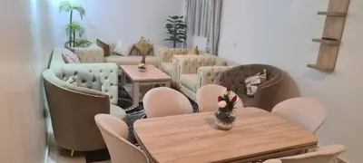 a living room with a table and chairs and a couch at Rabat in Temara