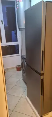 a kitchen with a refrigerator and a washing machine at Rabat in Temara