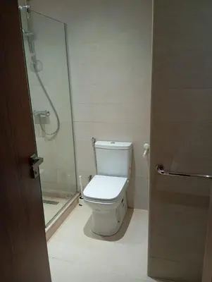 a bathroom with a toilet and a glass shower at Ennour in Rabat