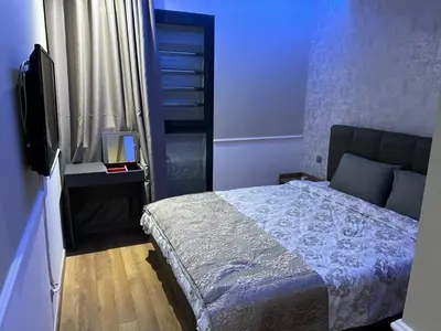 a bedroom with a bed and a television in it at Appartement dans un cadre convivial in Rabat