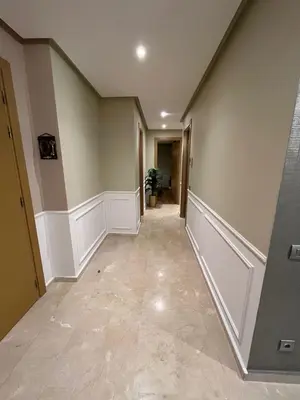 a hallway of a home with beige walls at Appartement dans un cadre convivial in Rabat