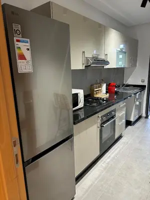 a kitchen with a stainless steel refrigerator and a stove at Cosy Appartement in Rabat