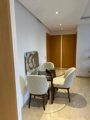 a dining room with a glass table and chairs at Cosy Appartement in Rabat