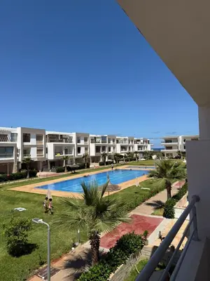 a view of a swimming pool from a balcony of a apartment at 2BR Beach Apt, Pool, Luxury place in Mansouria