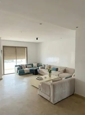 a living room with two couches and a coffee table at 2BR Beach Apt, Pool, Luxury place in Mansouria
