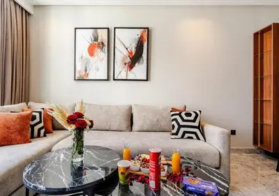 a living room with a couch and a glass table at Studio Luxe avec vue Magnifique WiFi Haut Debit et Netflix Inclus in Casablanca