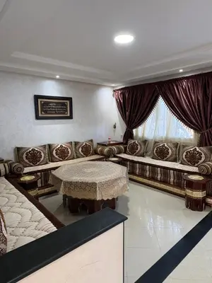 a living room with a table and a couch at VILLA Dar BOUAZZA, Vue sur mer, 200m de la plage in Dar Bouazza