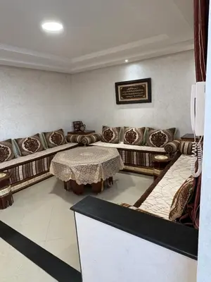 a living room with a table and couches at VILLA Dar BOUAZZA, Vue sur mer, 200m de la plage in Dar Bouazza