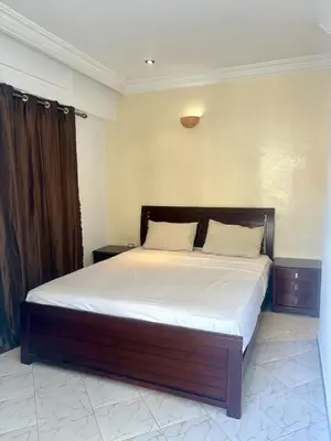 a bedroom with a large bed with white sheets at Apartment in Agdal, 3-min walk from Arribat Center in Rabat
