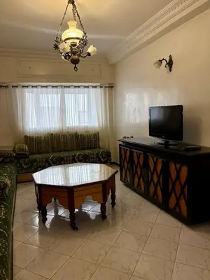 a living room with a couch and a tv at Apartment in Agdal, 3-min walk from Arribat Center in Rabat