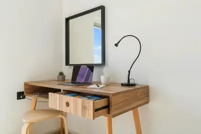 a wooden desk with a mirror and a lamp at Maya Suites - Seaside Luxury Apartment in Casablanca