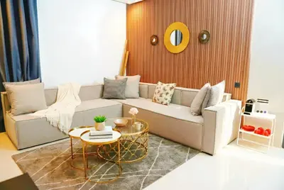 a living room with a couch and a table at Maya Suites - Seaside Luxury Apartment in Casablanca