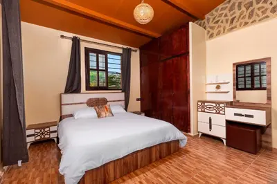 a bedroom with a bed and a window at La Tulipe de Zaer - Maison de Campagne vue Montagnes - Piscine Privée