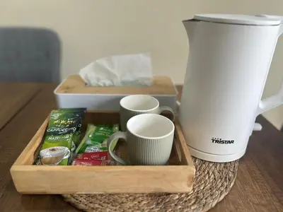 a tray with cups and a coffee maker on a table at Appartement Bouznika POOL & BEACH in Bouznika