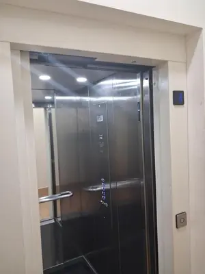a elevator in a building with a glass door at Appartement Bouznika POOL & BEACH in Bouznika