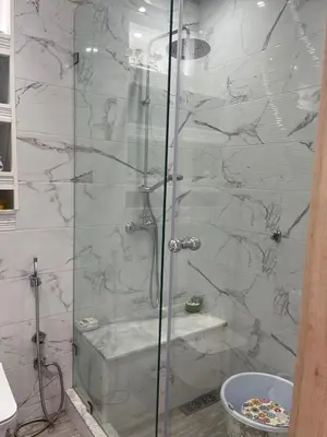 a shower with a glass door in a bathroom at Apartment with piscine in Mansouria