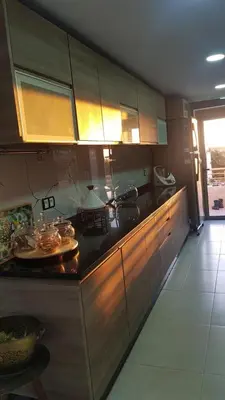 a kitchen with wooden cabinets and a counter top at Apartment with piscine in Mansouria