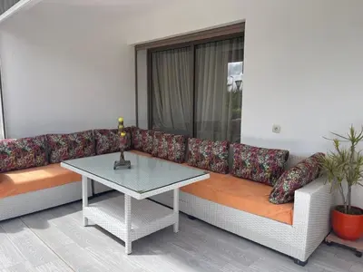 a living room with a couch and a table at Apartment with piscine in Mansouria