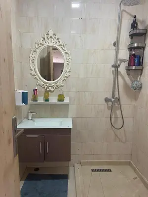 a bathroom with a sink and a shower with a mirror at Apartment with piscine in Mansouria
