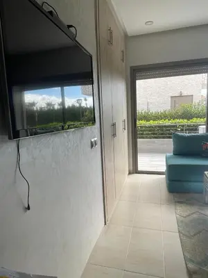 a room with a flat screen tv on a wall at Apartment with piscine in Mansouria