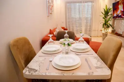 a dining room table with plates and utensils on it at R109- Outstanding 1 BR Aprt with Great View in Casablanca