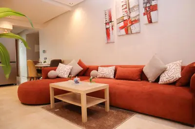 a living room with a red couch and a table at R109- Outstanding 1 BR Aprt with Great View in Casablanca