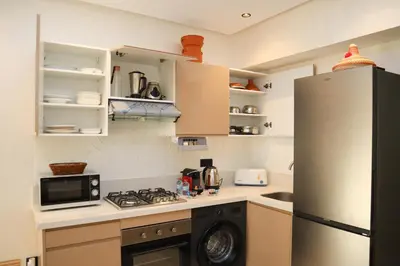 a kitchen with a refrigerator and a stove at R109- Outstanding 1 BR Aprt with Great View in Casablanca