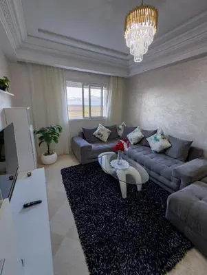 a living room with a couch and a table at artisanat in Mohammedia