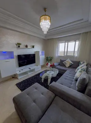 a living room with a couch and a television at artisanat in Mohammedia