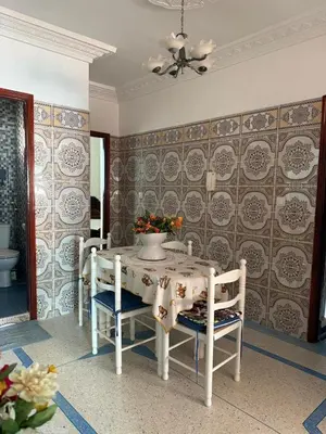 a dining room with a table and chairs at Appartement central à Témara, proche de Rabat in Temara