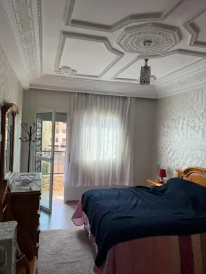 a bedroom with a bed and a coffered ceiling at Appartement central à Témara, proche de Rabat in Temara