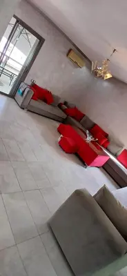 a living room with couches and red pillows at well-equipped apartment in Mansouria