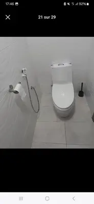 a bathroom with a toilet and a roll of toilet paper at well-equipped apartment in Mansouria