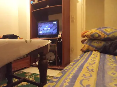 a bedroom with a bed and a tv in a room at Younes Home in Casablanca