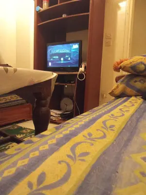 a room with a bed and a tv and a television at Younes Home in Casablanca