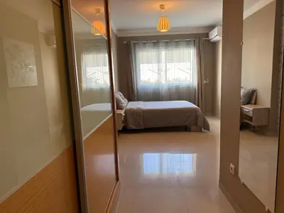 a bedroom with a bed and a mirror in a room at Cozy Downtown Apartment - Casa Port TGV in Casablanca